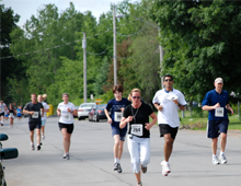 image of people running participating in a 5k run event for the All for One's chairty event