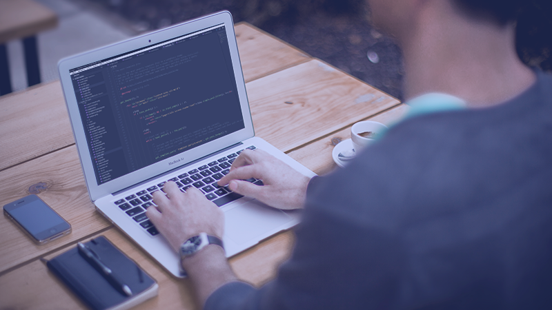 slider image of a man working on his laptop